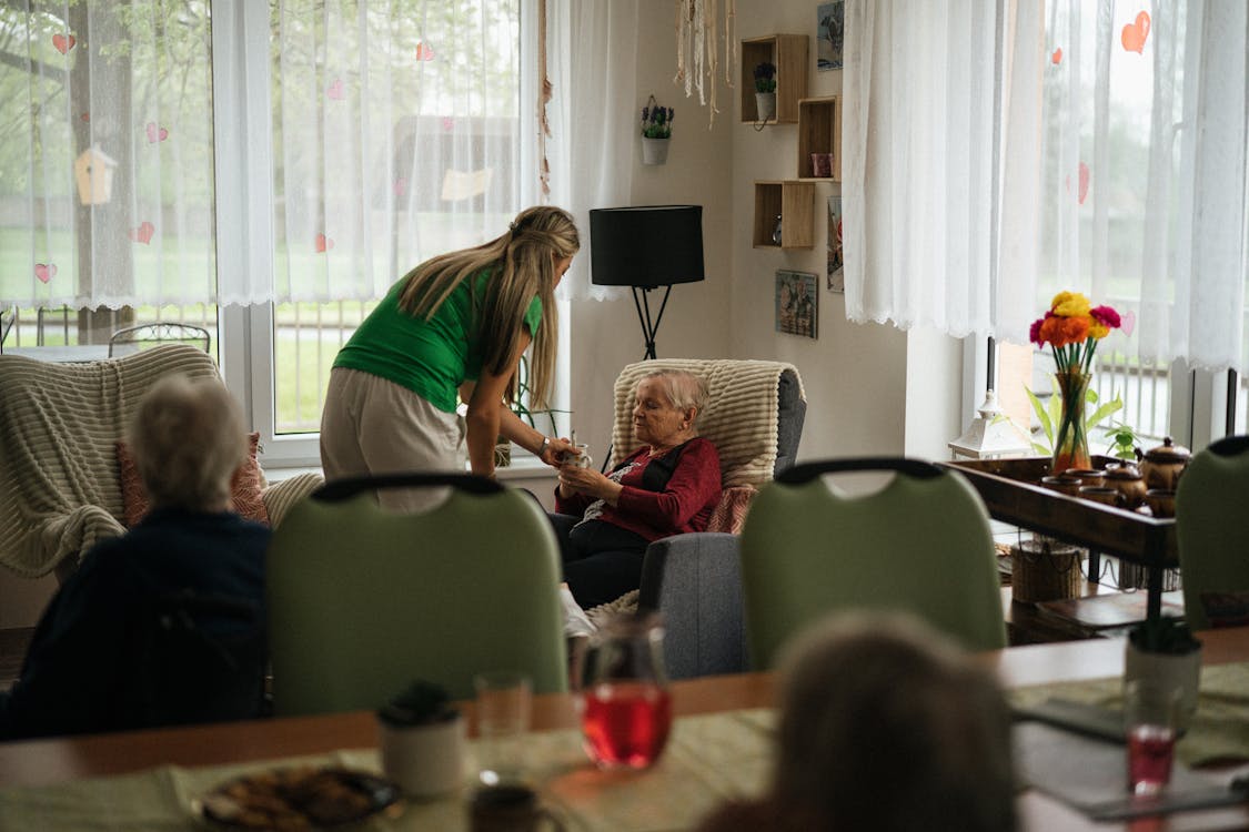 A caregiver helping elderly people in a nursing home
