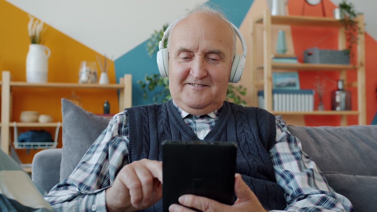 Senior listening to music with headphones